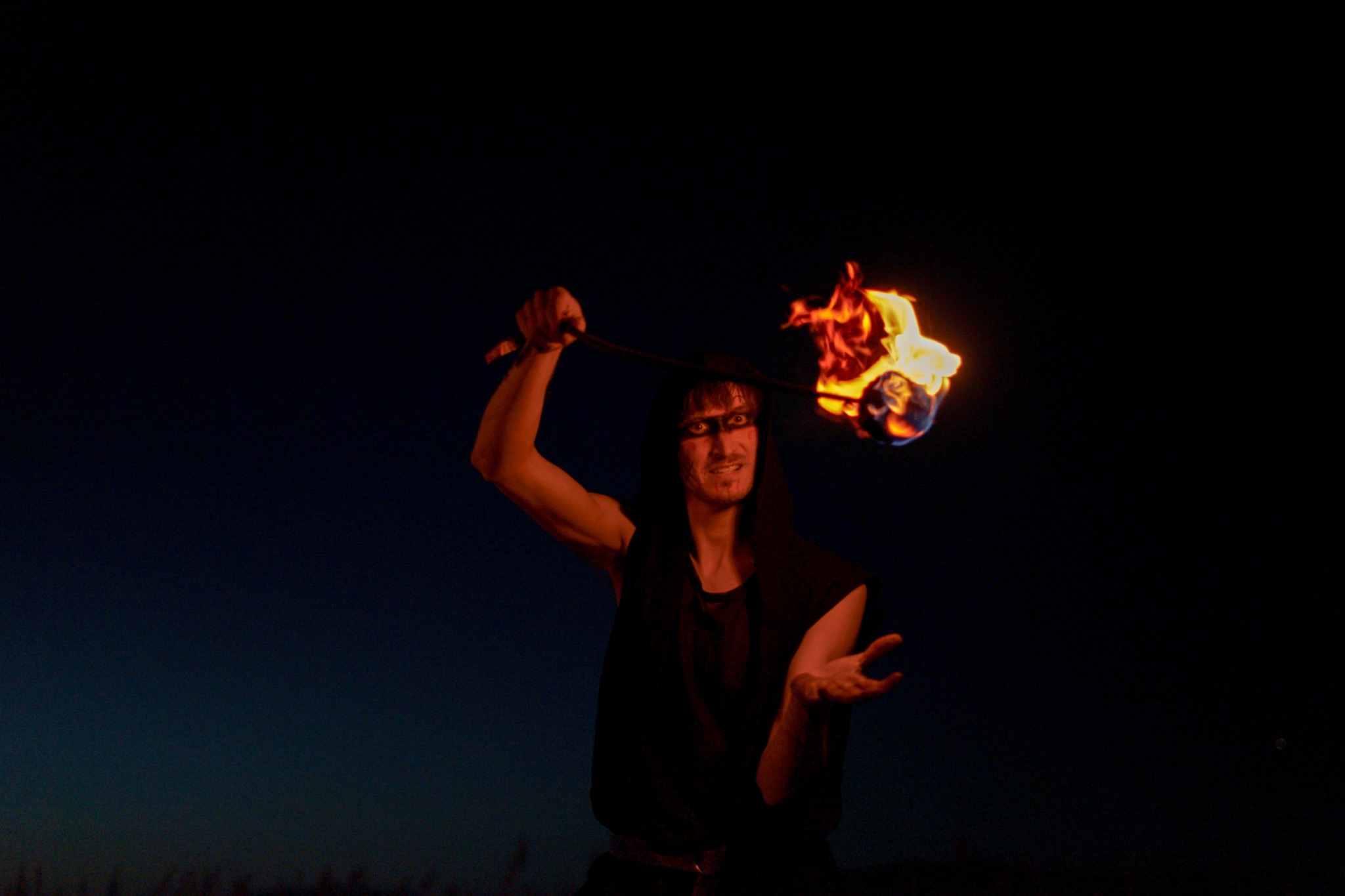Performer with fire at dusk